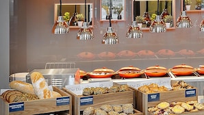 A breakfast buffet with various food items and a coffee station. - Holiday Inn Hamburg - Hafencity by IHG (Hamburg)
