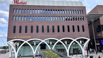 A Westfield shopping mall with a modern architectural design, featuring a prominent Westfield sign and a clear view of the entrance.