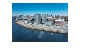 A waterfront cityscape with modern buildings, a marina, and a bridge. - Holiday Inn Hamburg - Hafencity by IHG (Hamburg)