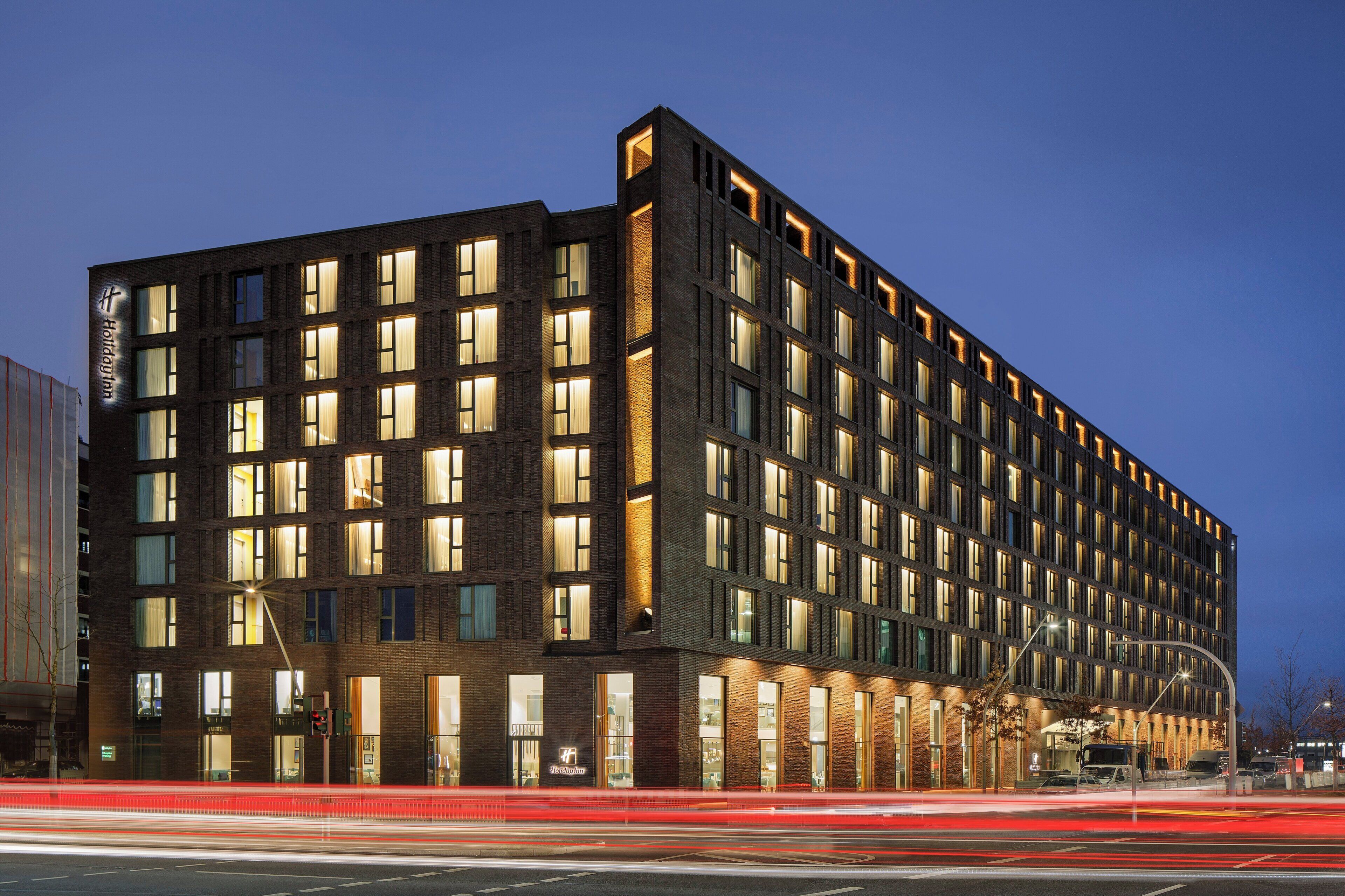A multi-story hotel with a brick facade and numerous windows.