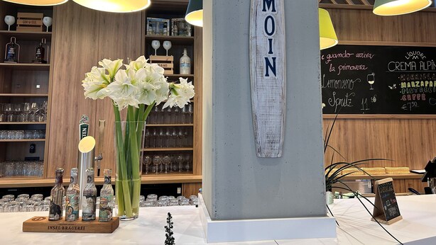 A bar area with a wooden interior, a chalkboard menu, and a large wooden sign with the word "MOIN". - Holiday Inn Hamburg - Hafencity by IHG (Hamburg)
