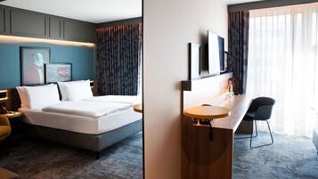 Hypo-allergenic bedding, desk, laptop workspace, blackout drapes