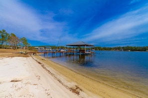 Relax by the serene lake with a stroll along the sandy beach and a peaceful retreat at the covered pavilion.