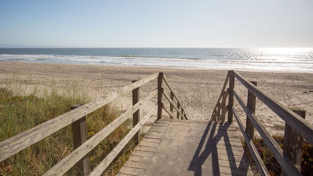 A wooden boardwalk leading to a beach with a clear view of the ocean. - Pajaro Dunes House 81 (Watsonville)