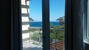Ein Balkon mit Blick auf das Meer und einen klaren Himmel.