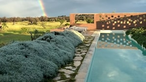 A pool area with a geometric pool design, surrounded by a landscaped garden with trimmed bushes. - LUXURY VILLA 4 BEDROOMS NEAR TO TORRE GUACETO BEACHES, CAROVIGNO,  OSTUNI (Serranova)