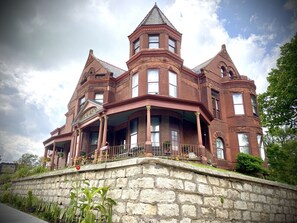 A large, historic brick building with a prominent tower and multiple windows.