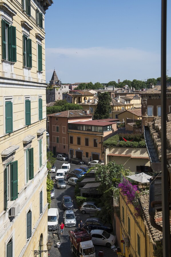 A narrow street lined with historic buildings, featuring a mix of residential and commercial properties.