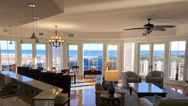 A spacious living area with a kitchen, dining area, and seating with ocean views. - Direct Gulffront! BREATHTAKING 270 degree Ocean Views! Large 2600 sqft 3bdrm! (WaterSound Beach)
