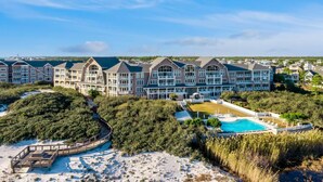 A large resort with multiple buildings, a swimming pool, and a beach area. - Direct Gulffront! BREATHTAKING 270 degree Ocean Views! Large 2600 sqft 3bdrm! (WaterSound Beach)