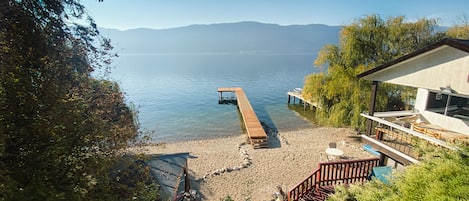 Escape to a serene lakeside retreat with a dock and peaceful views of the surrounding landscape.