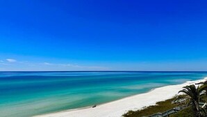 A beach with clear turquoise waters and a white sandy shore.