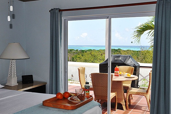 Master bedroom with spectacular ocean view, overlooking expansive balcony.
