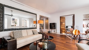 A modern living room with a sofa, coffee table, and dining area. - top luxury 3BR/3BA A/C art deco st honore architecturally designed (Paris)