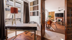 A modern living room with a dining area, a fireplace, and a TV. - top luxury 3BR/3BA A/C art deco st honore architecturally designed (Paris)