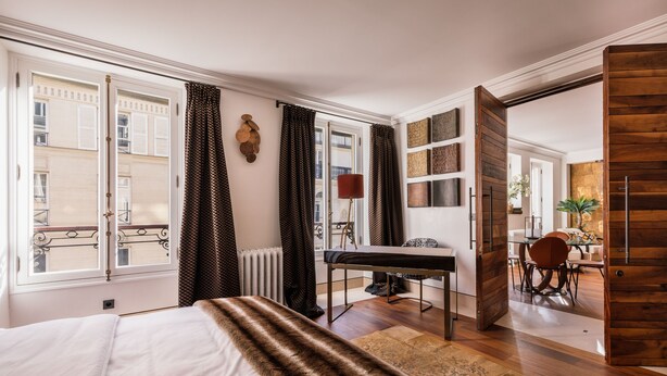 A hotel room with a bed, a desk, and a view of the city. - top luxury 3BR/3BA A/C art deco st honore architecturally designed (Paris)