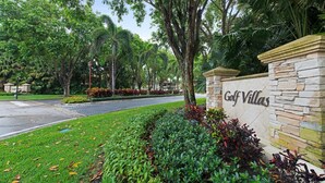 A landscaped area with a stone wall and the text "Golf Villas" indicating a resort or hotel.