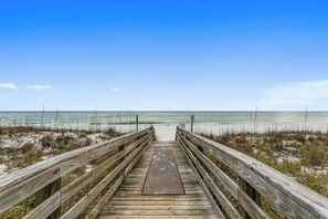 A wooden boardwalk leading to a beach with a clear sky. - 🏖️Escape to this Gulf front 2 BR / 2 BTH condo with swimming pool (Pensacola Beach)