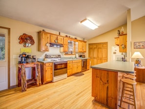 Enjoy cooking in this well-equipped kitchen with an oven, stovetop, and central island.