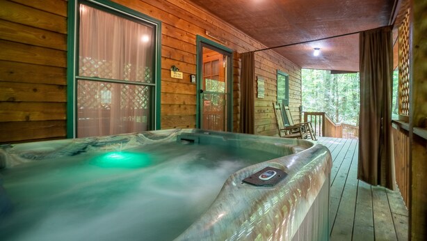 A wooden cabin with a hot tub, wooden walls, and a porch. - Bear Hug - Endorsed by Theodore Bear, a.k.a. "Teddy" (Sautee Nacoochee)