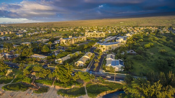 An aerial view of a resort with multiple buildings, roads, and greenery.