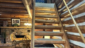 A wooden staircase with a handrail, leading to a higher floor. - Lake Barkley Log Cabin Getaway + Free Weekday Pontoon (seasonal)  (Cadiz)