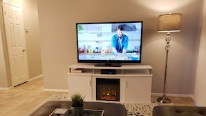 A living room with a fireplace, a television, and a sofa. - Beautiful oasis of luxury in the desert of North Scottsdale, Arizona (Scottsdale)