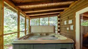 A hot tub in a wooden cabin with a view of the forest. - Love Bird - The Perfect Nest! (Sautee Nacoochee)