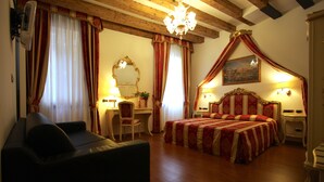 A bedroom with a large bed, a desk, a chair, a mirror, and a chandelier. - Grand Canal Apartment...Venetian Dream!!! All Inclusive Options! No Extras -WiFi (Venice)