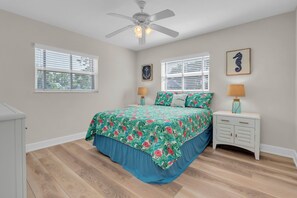 A bedroom with a bed, two bedside tables, a ceiling fan, and two windows with blinds. - Beautiful 3BD,2BA Waterfront Pool Home (Saint Petersburg)