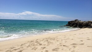 A beach with clear blue water, sandy shore, and large rocks. - Beautiful, Spacious 3 Story, Waterfront Condo Bimini, Bahamas - Sleeps 10 (South Bimini)