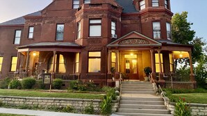 A large, historic brick building with a prominent tower and a grand entrance.