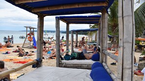 A beach with a bamboo structure providing shade. - The Cottage very comfortable, relaxing also secure, 5 minutes walk from beach (Ocho Rios)
