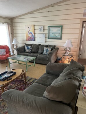 Relax in this inviting living room with a comfortable sofa, armchair, and coffee table.