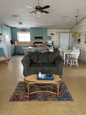 Enjoy a spacious living area with a kitchen, dining space, and comfortable seating.