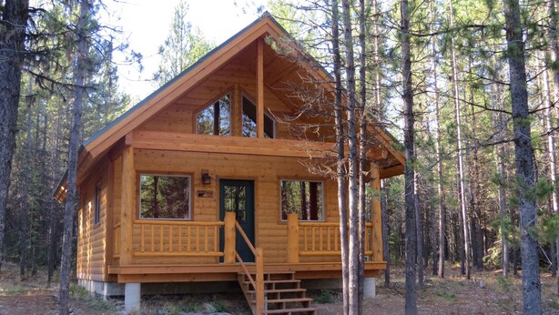 A wooden cabin with a balcony, large windows, and a staircase leading to the entrance. - A little heavenly peace, cabin No. 2 (Polebridge)