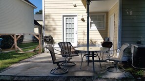 Enjoy a quiet moment on the patio with a round table and two chairs.