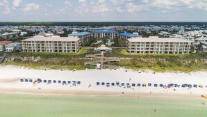 A beachfront hotel with multiple buildings, a sandy beach, and a pier. - Pool Front at High Pointe Resort-Ground Floor Unit (Panama City Beach)