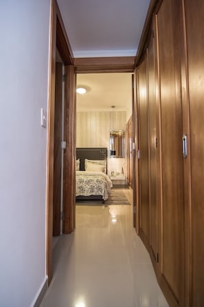 Comfortable sleeping area with ample storage and a stylish bed.