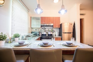 Enjoy cooking in this well-equipped kitchen with a central island, stove, and oven, perfect for preparing meals.