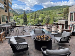 A rooftop terrace with outdoor seating, a fire pit, and a view of a mountain landscape. - Charlie's Slopeside: Ski-In/Out, Ski Valet, Resort Amenities, Pool + Hot Tubs (Avon)