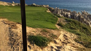 A coastal golf course with a sandy path, green fairways, and rocky outcrops. - 26 SPRING-SUMMER DATES AVAILABLE IN 3 & 4-BEDROOM MONTECRISTO VILLA &OPTION AI… (Cabo San Lucas)