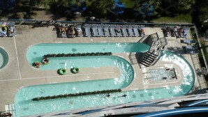 An aerial view of a swimming pool complex with multiple lanes, a diving platform, and lounge chairs. - "Direct" Ocean Front 9th Floor cozy coastal cottage Reasonable Rates (Myrtle Beach)