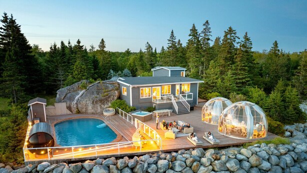 A lakeside cabin with a swimming pool, outdoor seating, and glass domes. - Relaxing Oceanfront Retreat . Hot tub -sauna-pool-clear domes-private (South Shore)