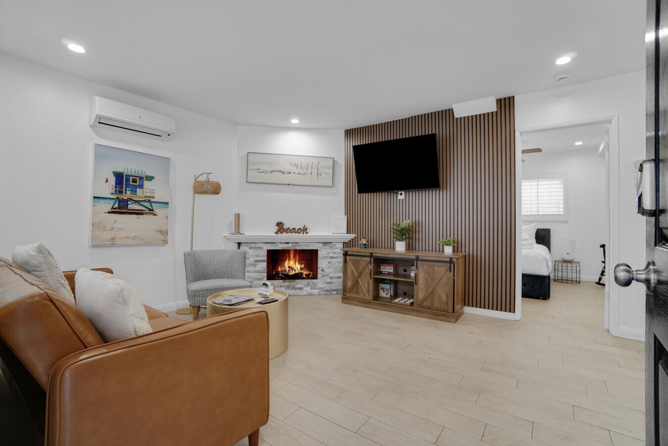 A living room with a fireplace, a television, and a sofa.