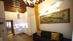 A modern kitchen with white cabinets, a wooden ceiling, and a dining area with a yellow curtain. - SPLENDID STAR SAN MARCO SQUARE - Magic Dream ! All Inclusive Options-WIFi (Venice)
