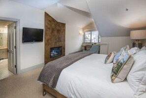 The primary bedroom includes a wall-mounted TV.