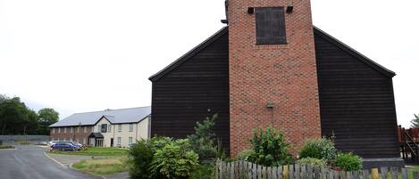 A building with a sign reading "THE LOCKKEEPER" on a brick wall.