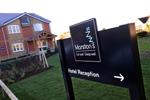 Señal para la recepción del Hotel Marston, con una flecha apuntando a la derecha.