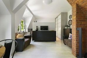 Apartment | Living area | Flat-screen TV, fireplace - Elite Apartments City Center Cosy Attic (Gdansk)